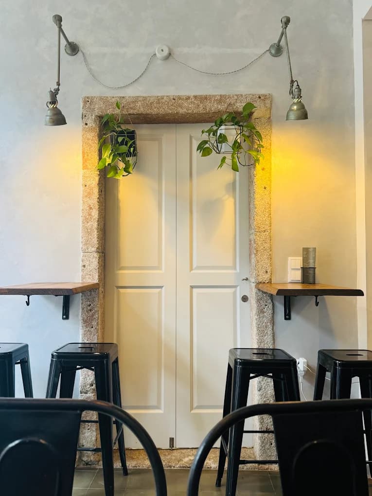 Inside Balta: the white door between two lamps, with high stools at the counter